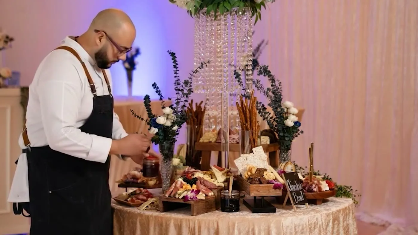 A chef preparing a charcuterie display at Nencini Ballroom