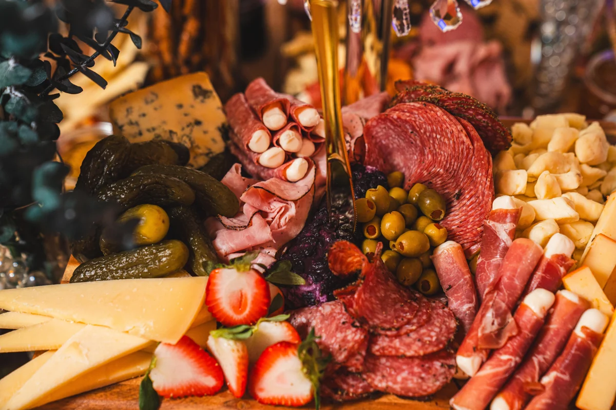 Charcuterie, cheese, olives and strawberries arranged for guests